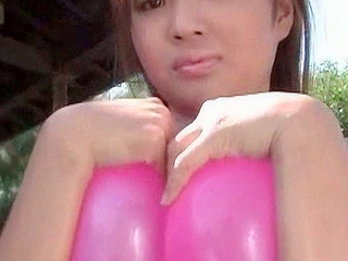 Japanese teen playing with balloons with her nipples exposed